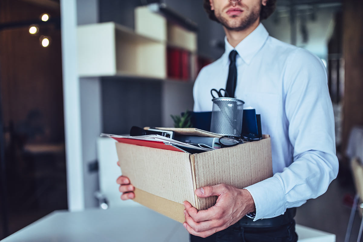 Man carrying box after losing job-How to Prepare Financially for Job Loss