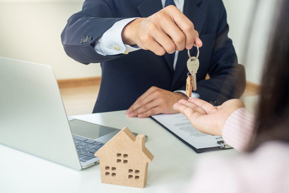 real estate agent handing keys over to client